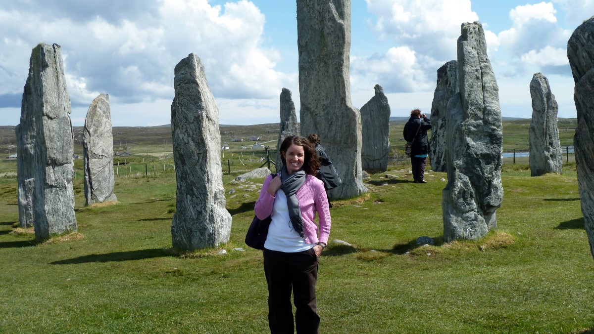 Amy standing with the Circle Stones behind her. Over her left shoulder is the monolith and over the right is the submerged burial chamber.