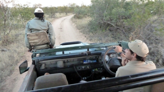 Gregg, our Guide, with Richard, our Tracker, perched on the hood