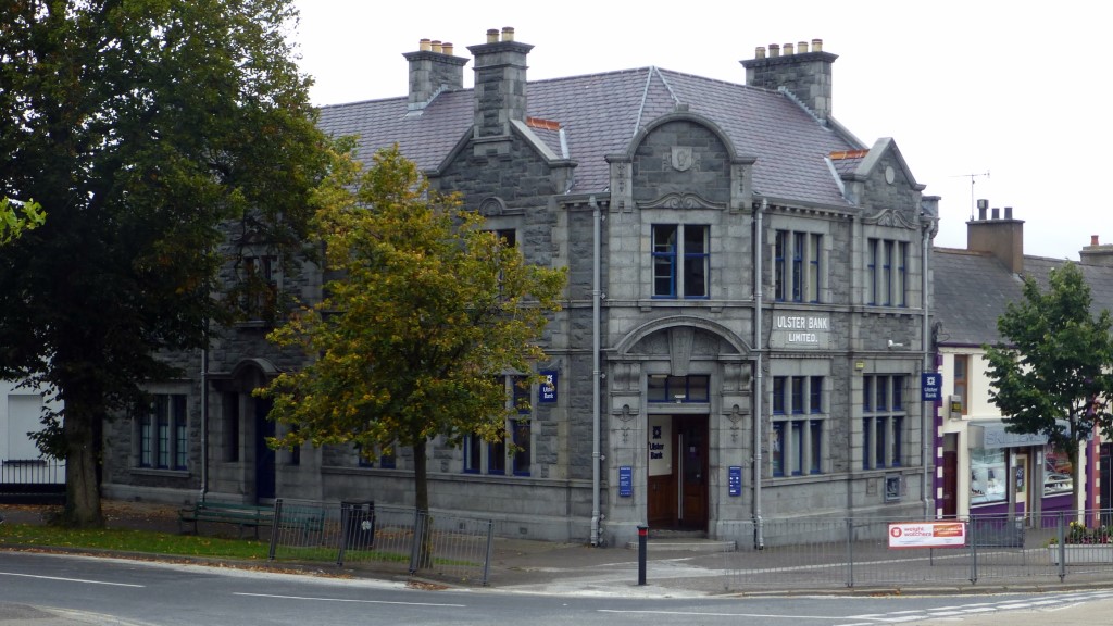 The Ulster Bank building across from the Oak Grill dates to 1923, but I believe the building is older.