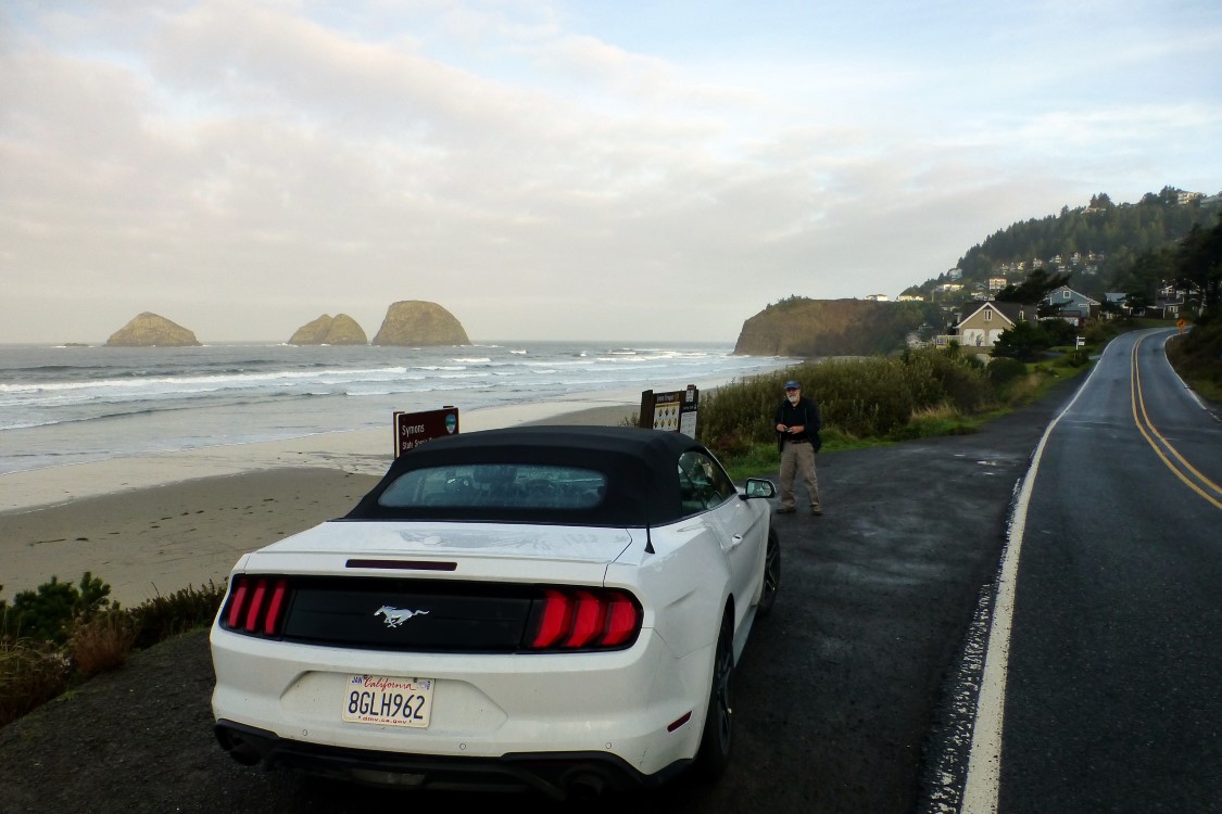 Our first stop of the day would be indicative of much of the coastline this day. Behind our trusty steed you see the Three Arches Rocks, (l-<wbr>r) Storm Rock, Finley Rock and Shag Rock lying just off of Maxwell Point near Oceanside, OR.