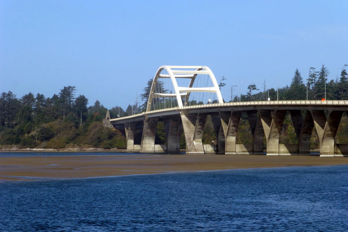 The Alsea Bay bridge was the first bridge designed by Conde McCullough and opened in 1936. The main span is 450 feet in length and clears 70 feet above the bay.