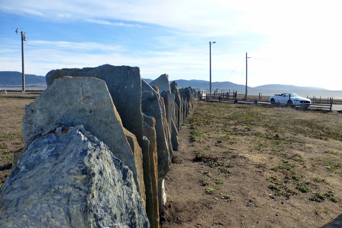 The Port Arena Lighthouse fence is constructed of vertical slabs of slate.