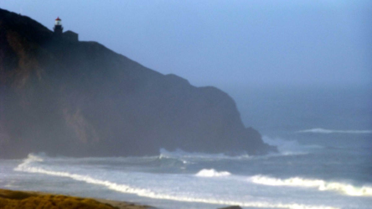 Perched high on the side of Point Sur, you see the Point Sur Lighthouse.