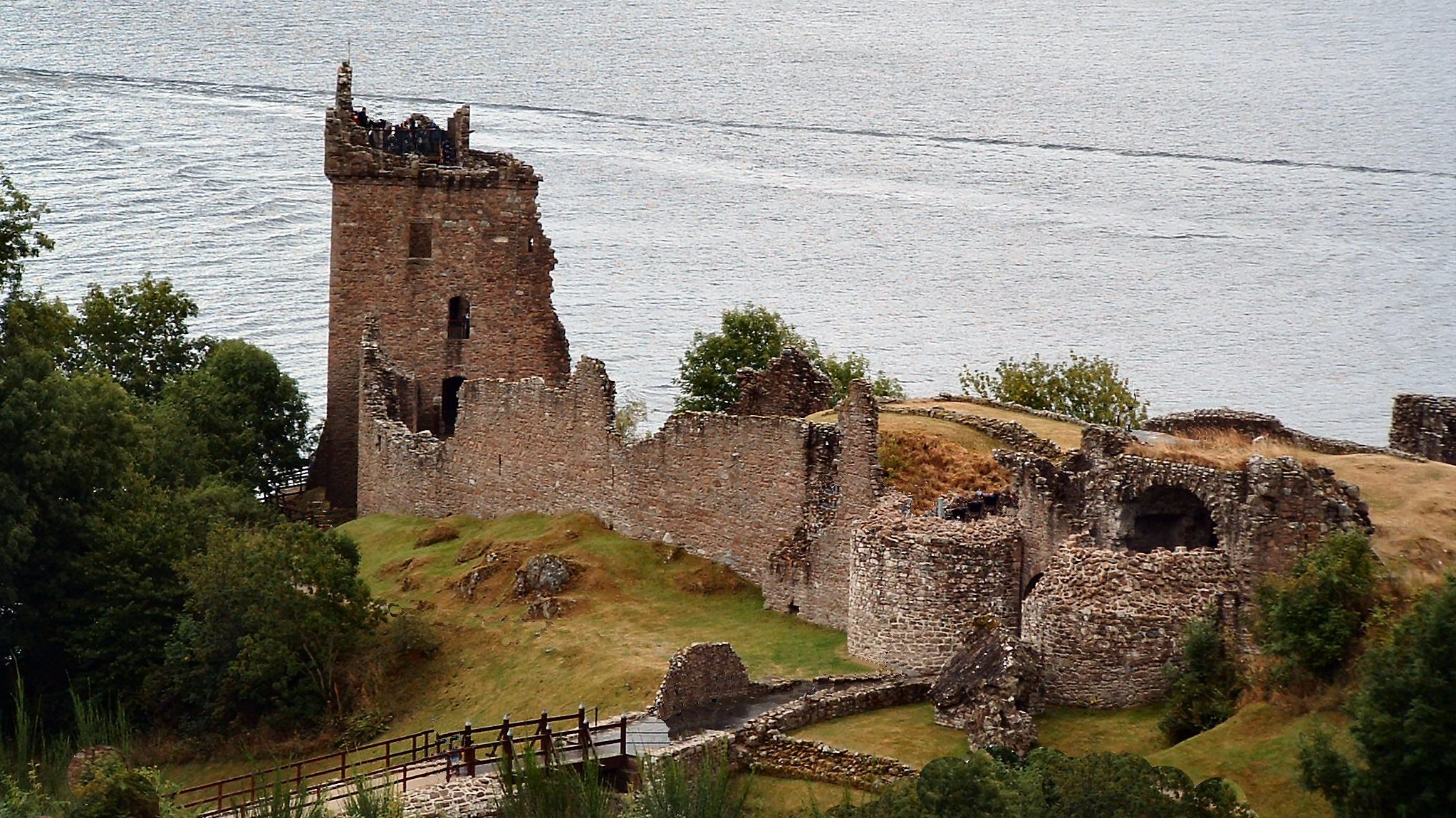 Urquhart Castle sits on a promontory overlook Loch Ness. Perhaps that is Nessies' wake in the background. (2003)