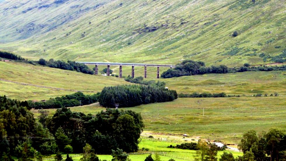 Further up the road, the railway crosses a small river.