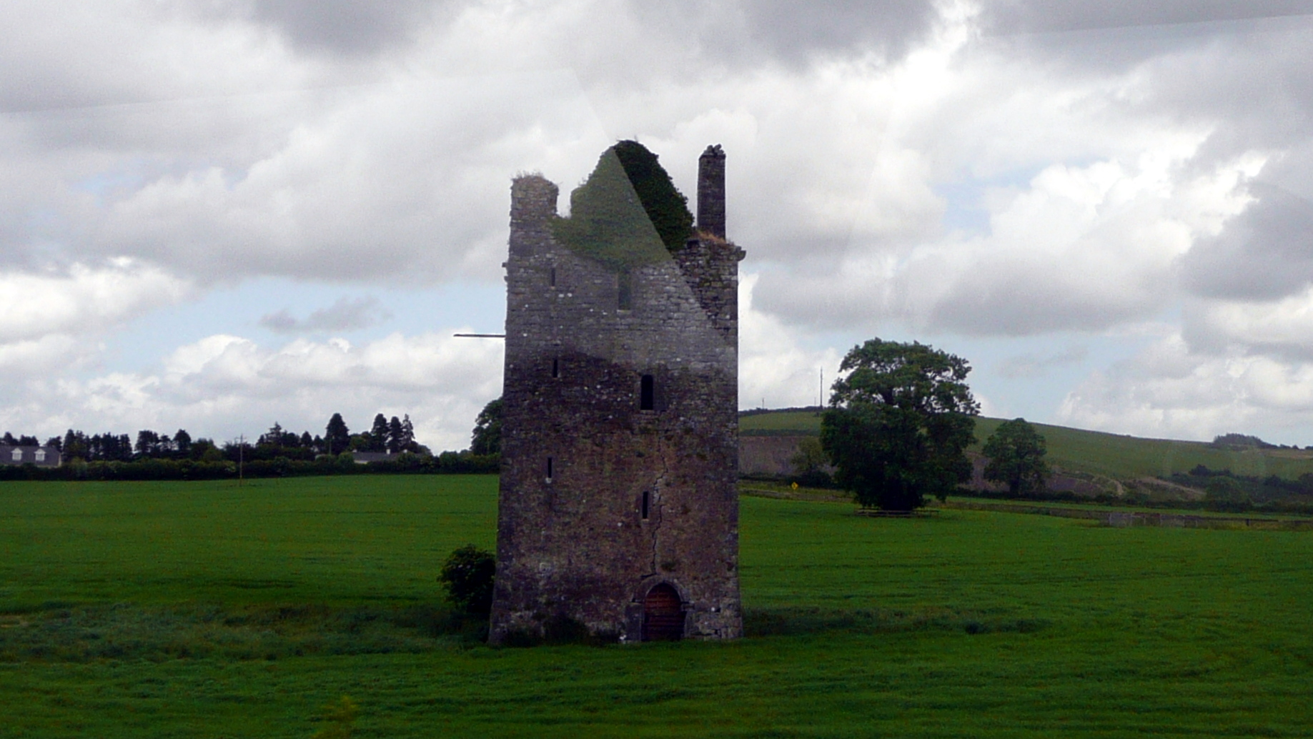 Another abandoned castle sitting in an open field.