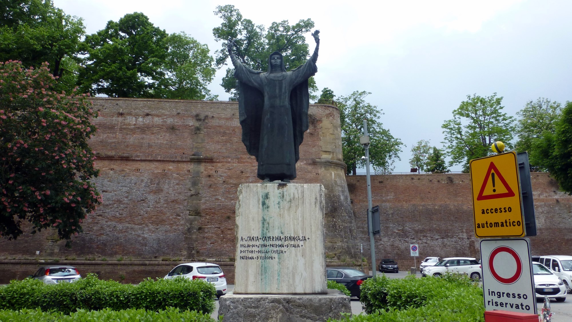 On the southeast corner of the fortess is this statue. The inscription reads <q>To Santa Caterina Benincasa, Daughter of Siena, Patron Saint of Italy, Doctor of the Church, Patron Saint of Europe</q>