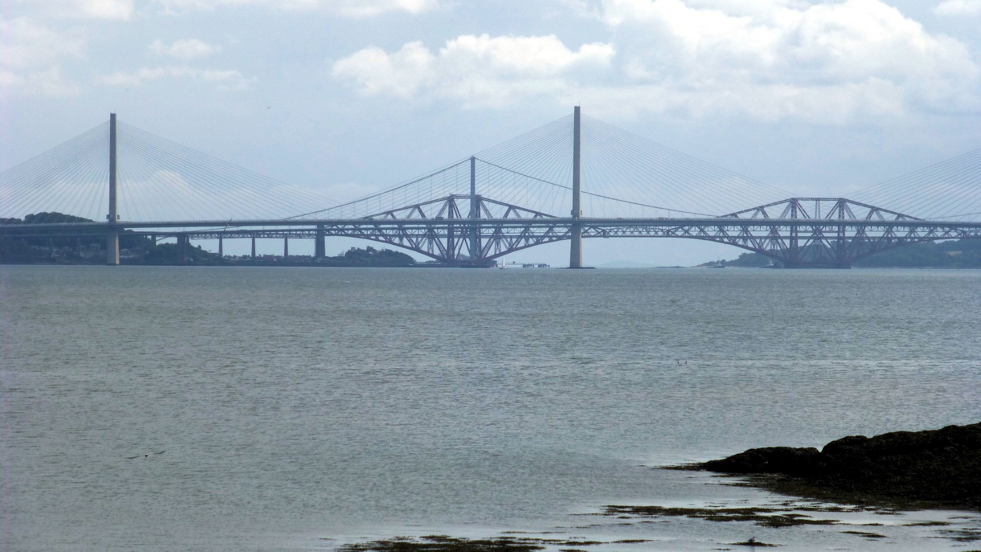 Looking east down the Firth of Forth to (in order near to far) the Queensberry Crossing Bridge, the Forth Road Bridge and the Forth (Rail) Bridge.