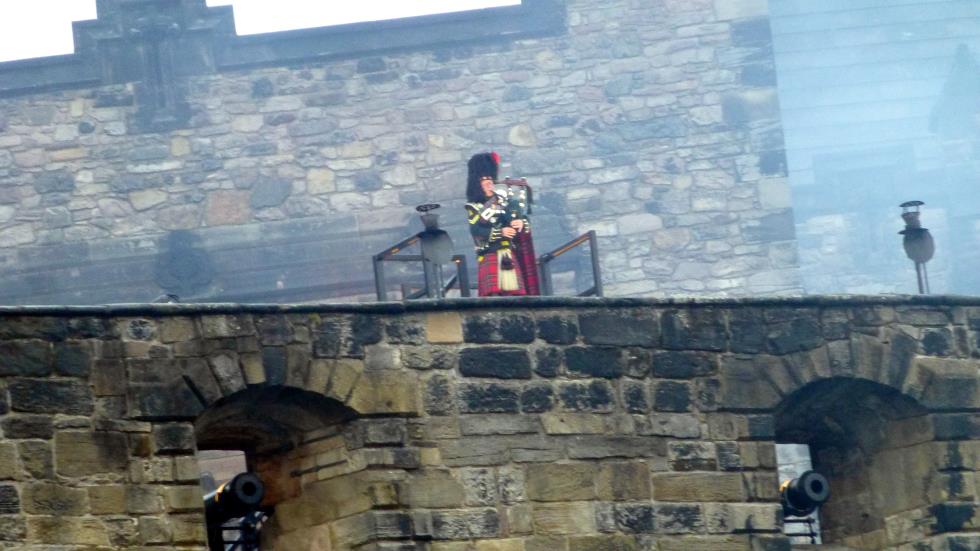 The Lone Piper atop the castle battlements as the show draws to an end.