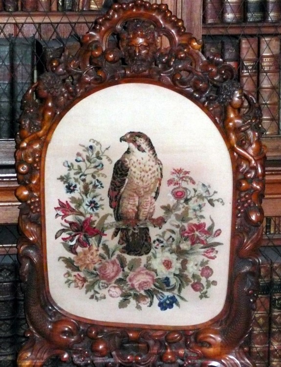 A seat back with a porcelain Falcon.