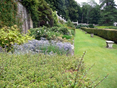 The gardens include benches, hedges and stonework.