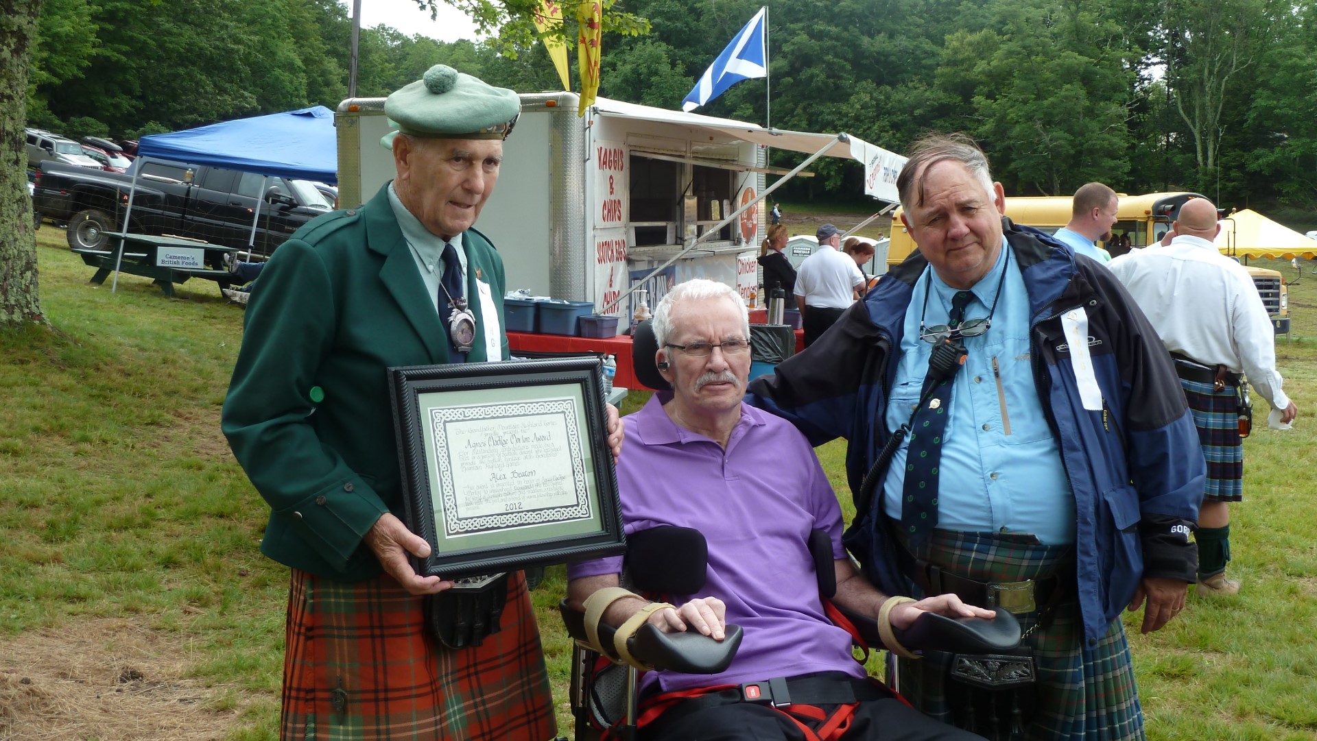 Ross Morrison, President,  And Frank Grant, Gen Mgr, Present Alex with the  Agnes MacRae Morton  Award for his outstanding  contribution to promoting  Scottish heritage at the  Grandfather Mountain  Highland Games