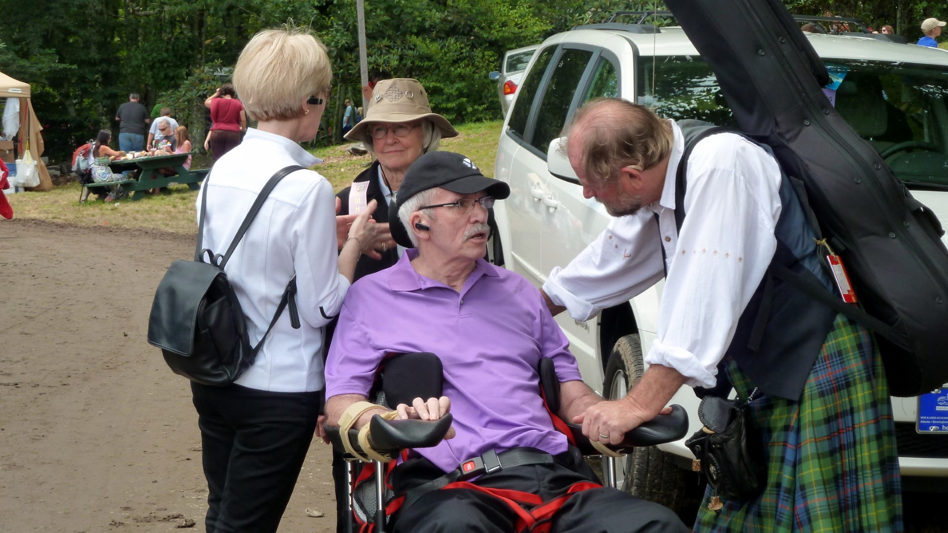 Alex speaks with Ed Miller as he leaves the field.  Ed performed on Alex’s stage that day and performed  many of Alex’s recordings. Behind Alex talking to Linda is Marnie Campbell, Bob’s wife.