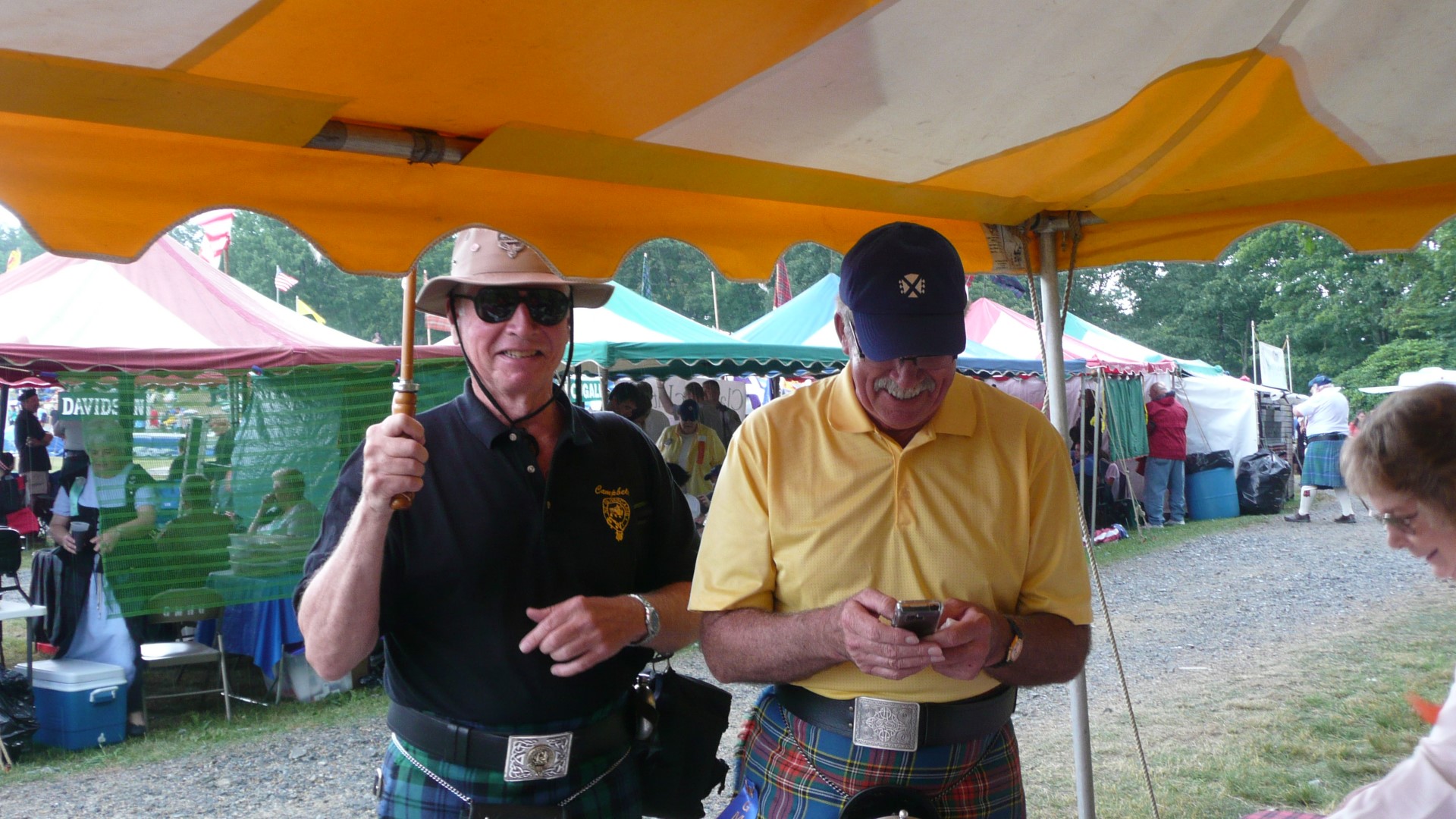 Alex tweets while Bob Campbell stands in the rain.